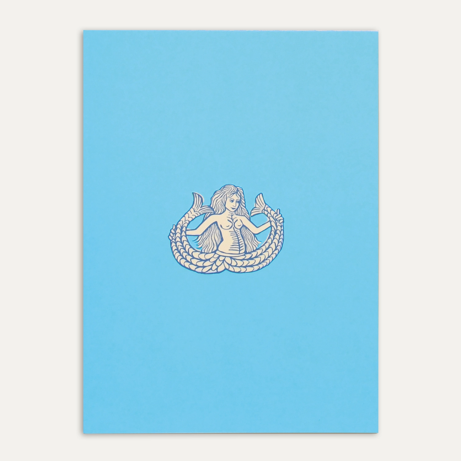 Still-life del Quaderno Ondina con copertina azzurra ispirata al mito della sirena bicaudata